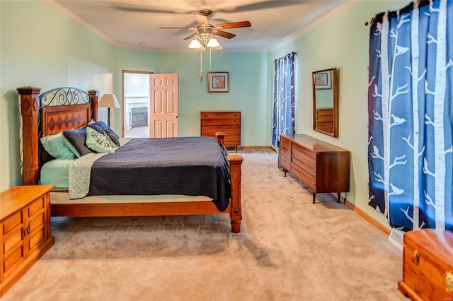 bedroom featuring crown molding, light carpet, and ceiling fan