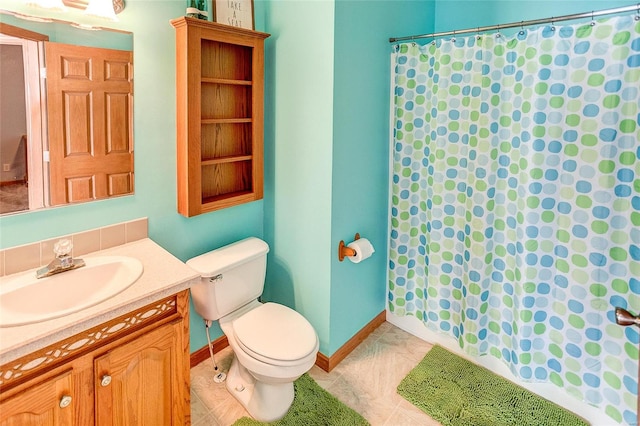 bathroom featuring vanity, toilet, and tile patterned floors