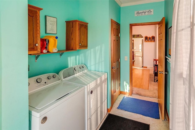 laundry room with independent washer and dryer, light tile patterned flooring, ornamental molding, and cabinets