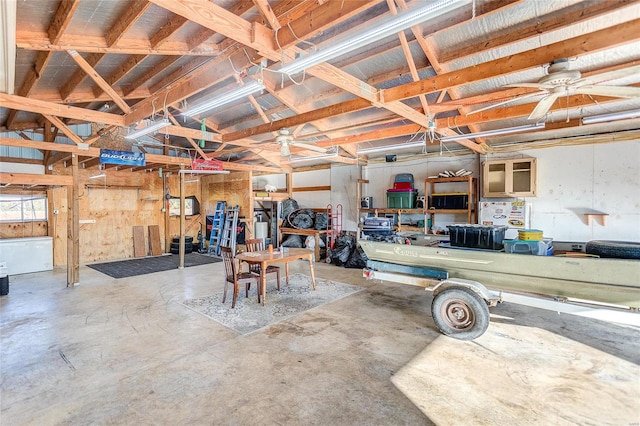 garage with ceiling fan and a workshop area