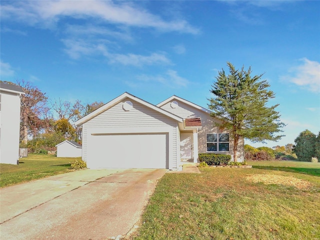 view of front of property with a front yard and a garage