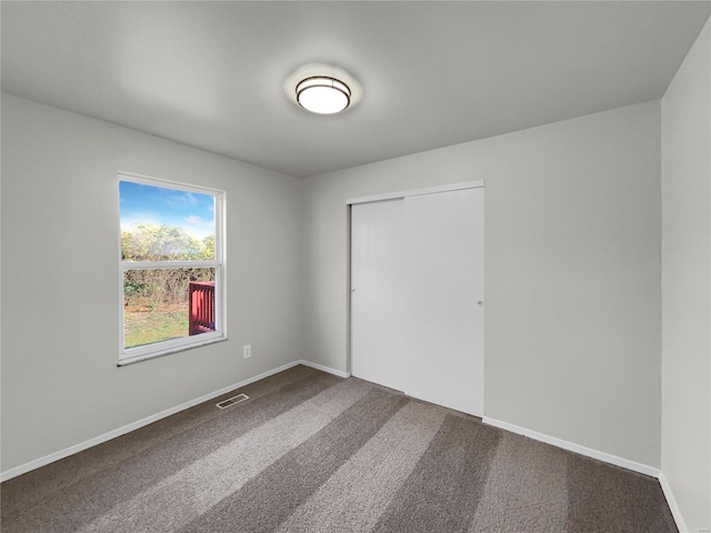 unfurnished bedroom with a closet and carpet flooring