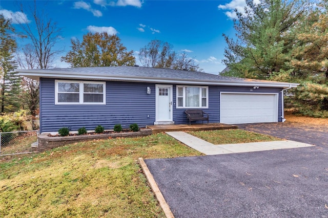 single story home featuring a garage and a front lawn