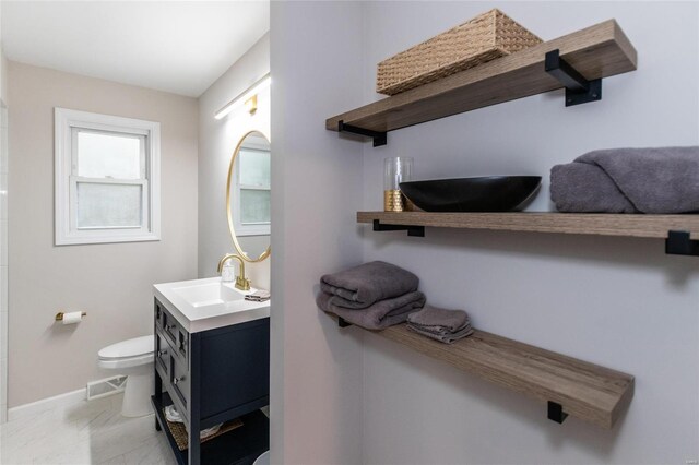 bathroom featuring vanity and toilet