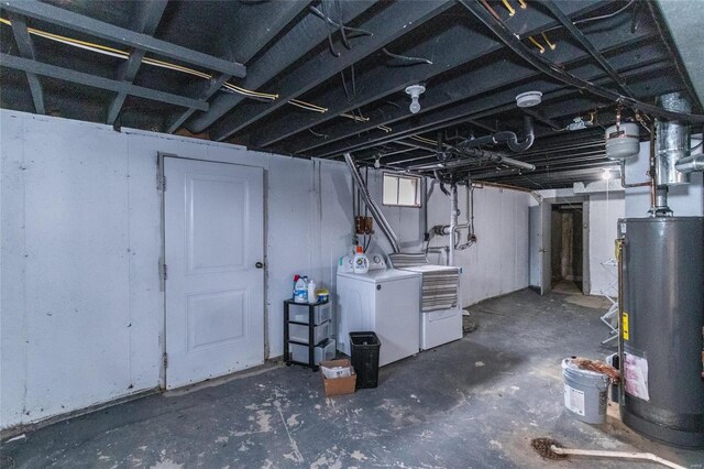 basement featuring water heater and washing machine and dryer