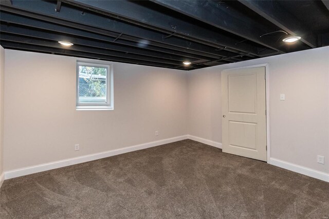 basement with dark colored carpet