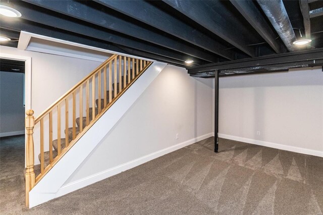 basement with dark colored carpet