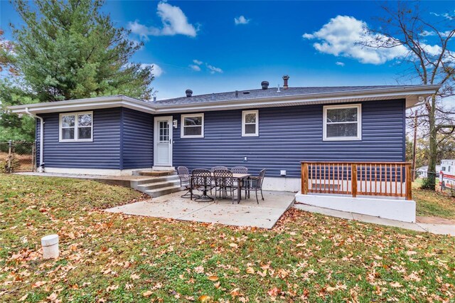 back of property with a patio and a lawn