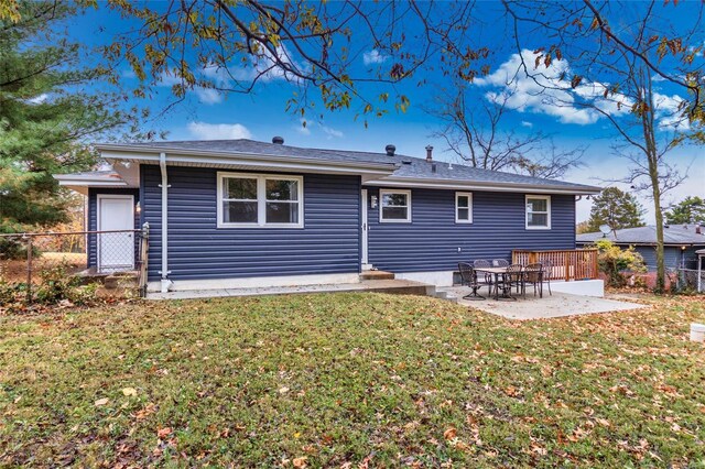 back of property featuring a patio area and a lawn