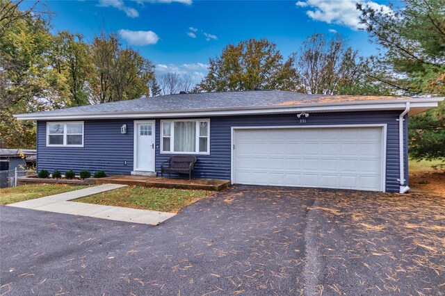 single story home featuring a garage