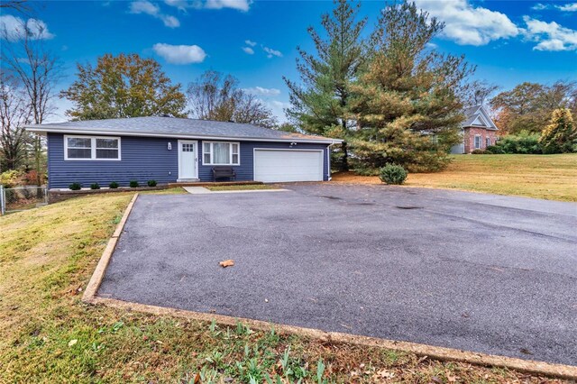 single story home with a garage and a front lawn