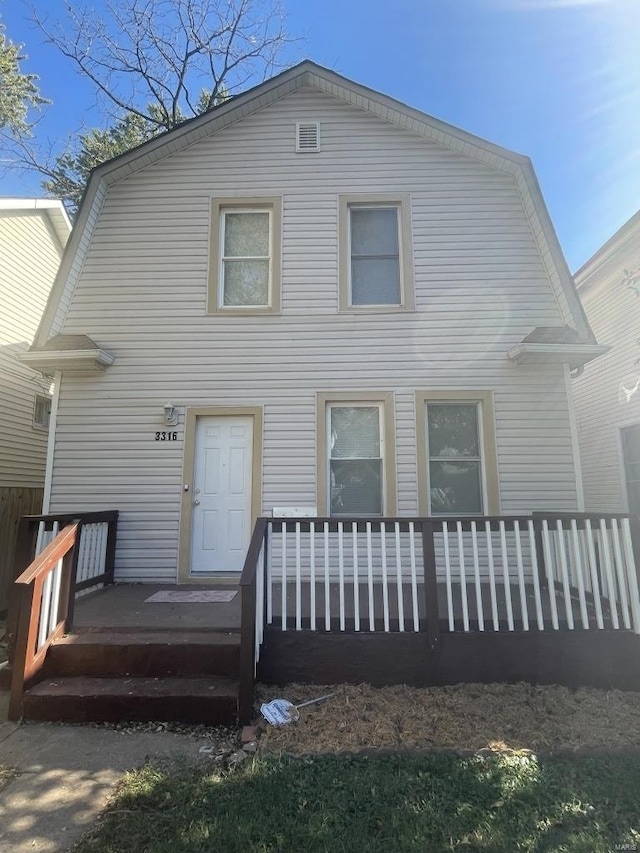 back of house featuring a deck