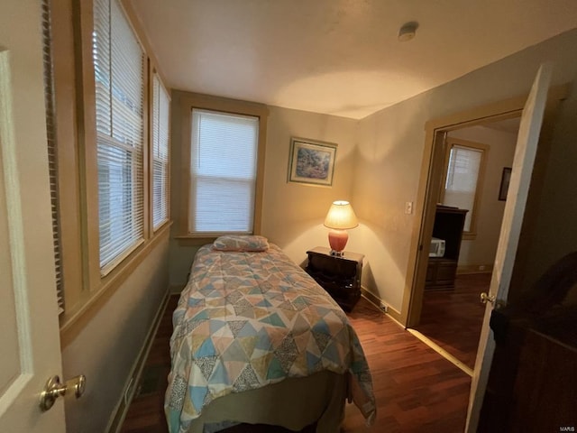 bedroom with dark hardwood / wood-style flooring