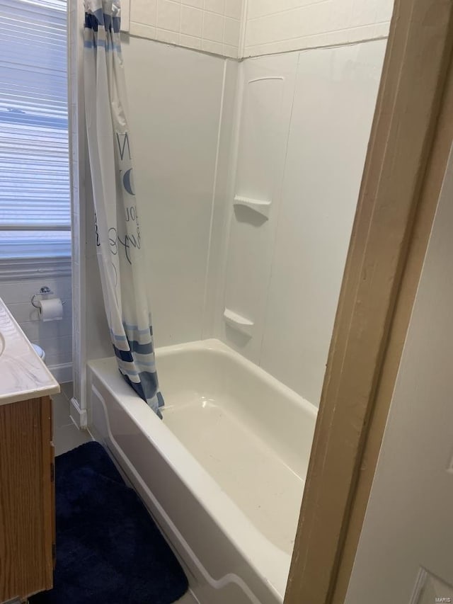 bathroom with vanity and shower / tub combo