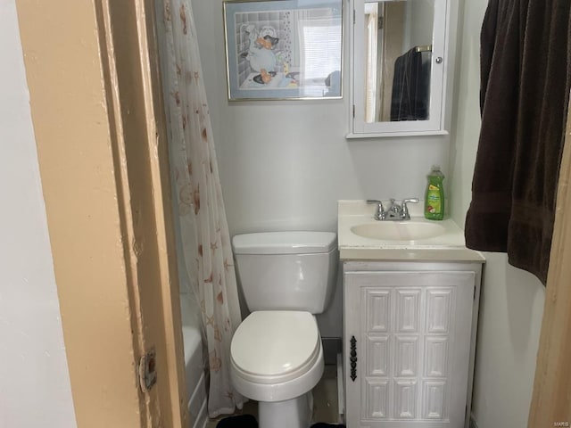 full bathroom with vanity, shower / bath combo with shower curtain, and toilet