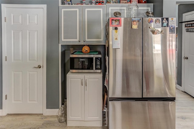 kitchen with appliances with stainless steel finishes and light wood-type flooring