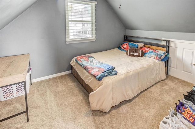 carpeted bedroom with vaulted ceiling