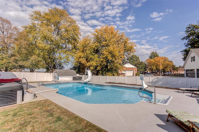 view of pool featuring a patio and a water slide