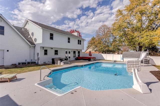 view of pool with central air condition unit and a patio