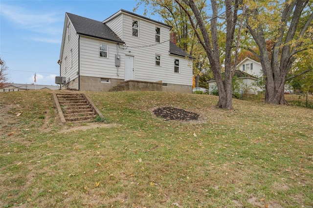 rear view of property with a yard