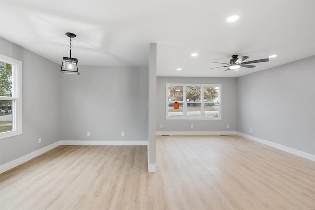 unfurnished living room with ceiling fan and light hardwood / wood-style flooring