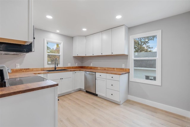 kitchen with white cabinetry, a wealth of natural light, butcher block counters, and sink