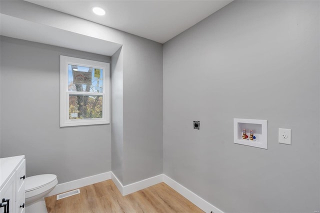 washroom featuring hookup for an electric dryer, washer hookup, and light wood-type flooring