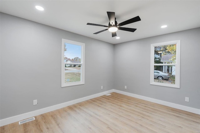 spare room featuring light hardwood / wood-style floors and ceiling fan