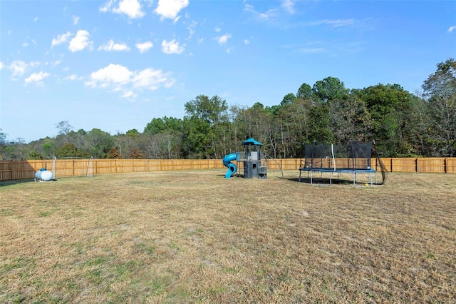 view of yard featuring a playground and a trampoline