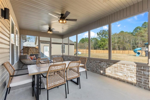 sunroom featuring ceiling fan