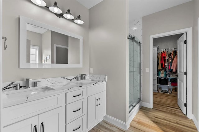 bathroom with vanity, an enclosed shower, and hardwood / wood-style floors