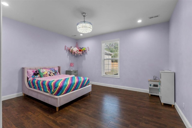 bedroom with dark hardwood / wood-style flooring