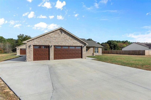 view of front of home with a front yard and a garage