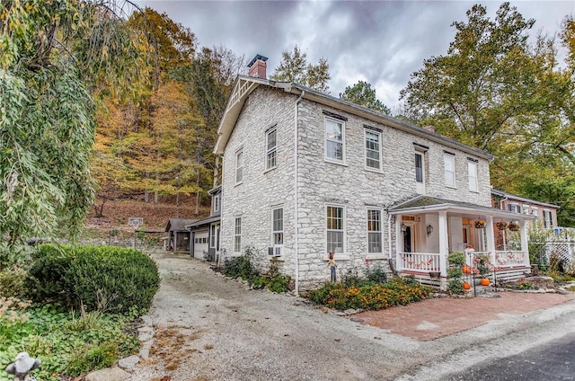 view of front of property featuring a garage and a porch