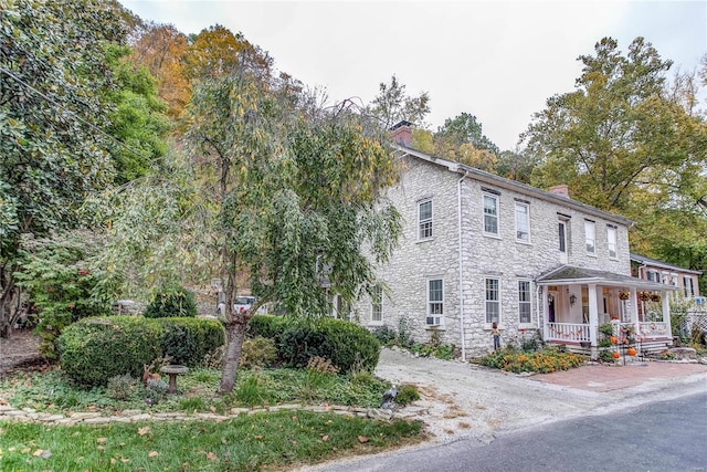 view of front of home featuring covered porch and cooling unit