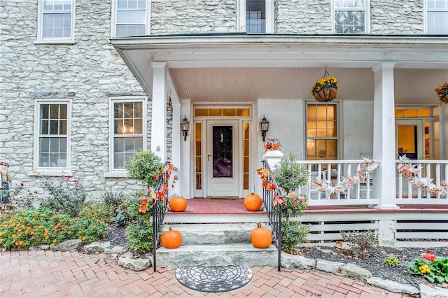 doorway to property featuring covered porch