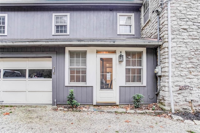 property entrance featuring covered porch and a garage