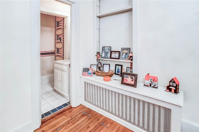 hall featuring light hardwood / wood-style flooring and radiator heating unit