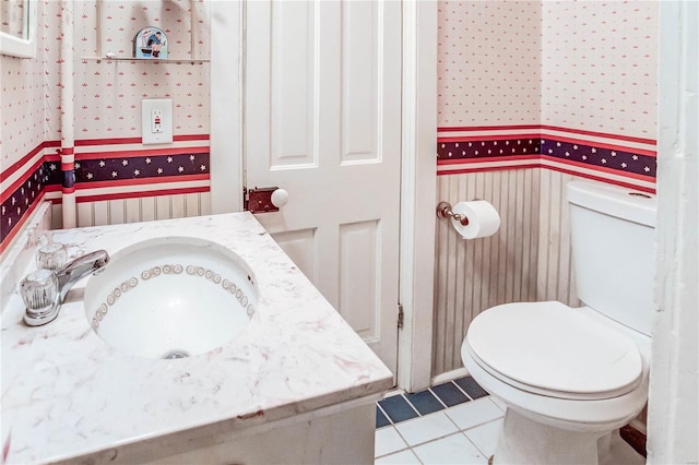 bathroom featuring vanity, toilet, and tile patterned floors