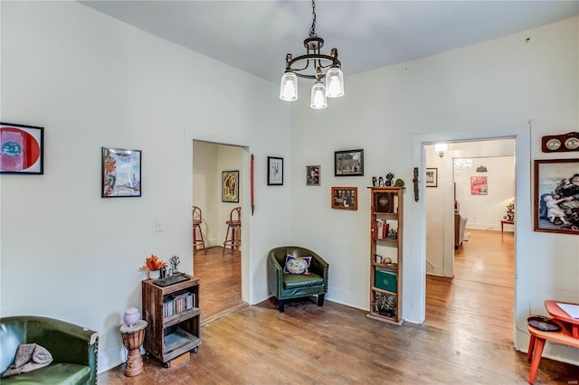 sitting room with a notable chandelier and wood-type flooring