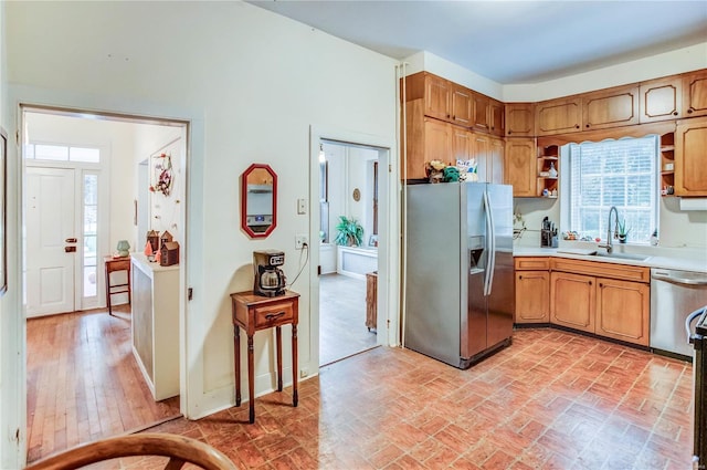 kitchen with light hardwood / wood-style floors, stainless steel appliances, and sink