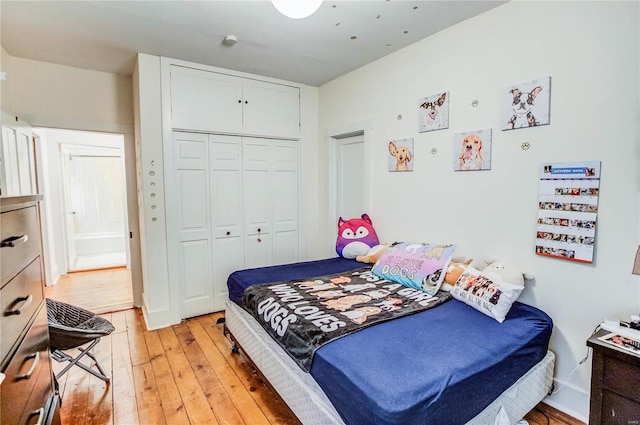 bedroom with light hardwood / wood-style flooring and a closet