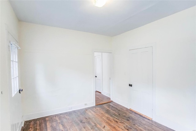 spare room featuring dark hardwood / wood-style floors