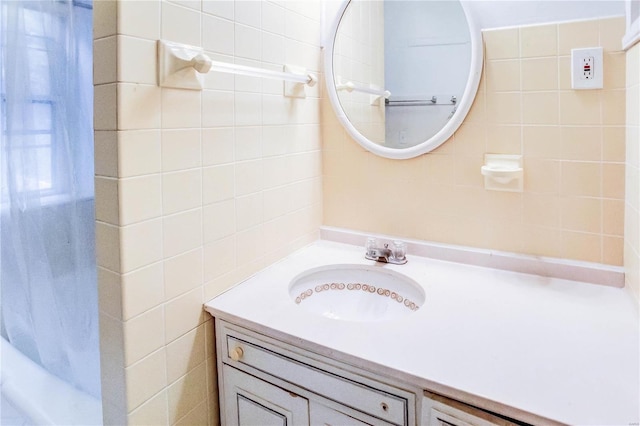 bathroom featuring vanity and tile walls