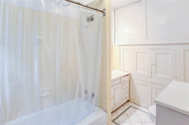 full bathroom with vanity, shower / bath combo with shower curtain, toilet, and tile patterned floors