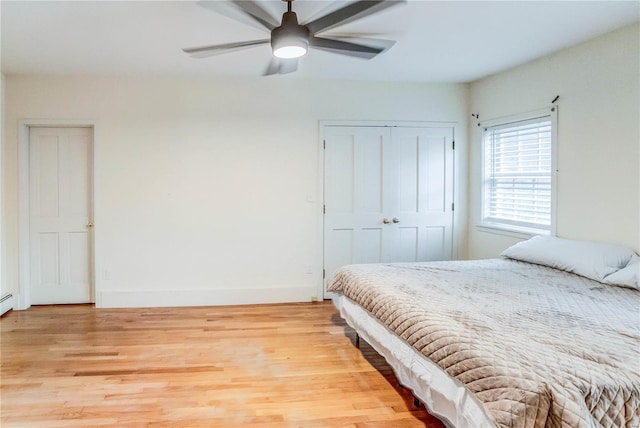 bedroom with ceiling fan and light wood-type flooring