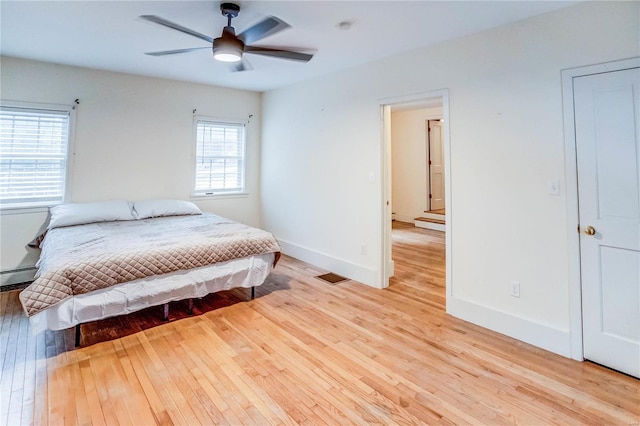 bedroom with light wood-type flooring and ceiling fan