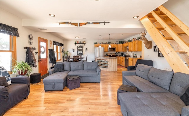 living room with light wood-type flooring and sink