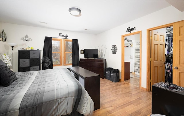 bedroom with light hardwood / wood-style flooring and a closet