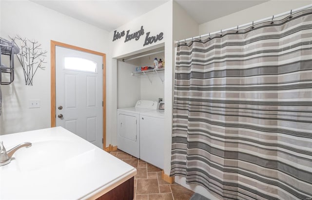 bathroom with vanity, washer and clothes dryer, and tile patterned floors